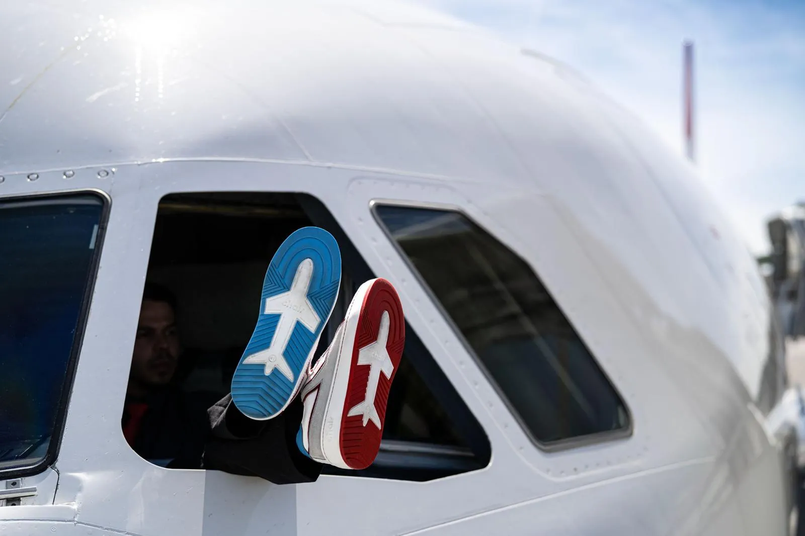 Pilot's feet at the cockpit window, Chair Airlines branded soles in close detail