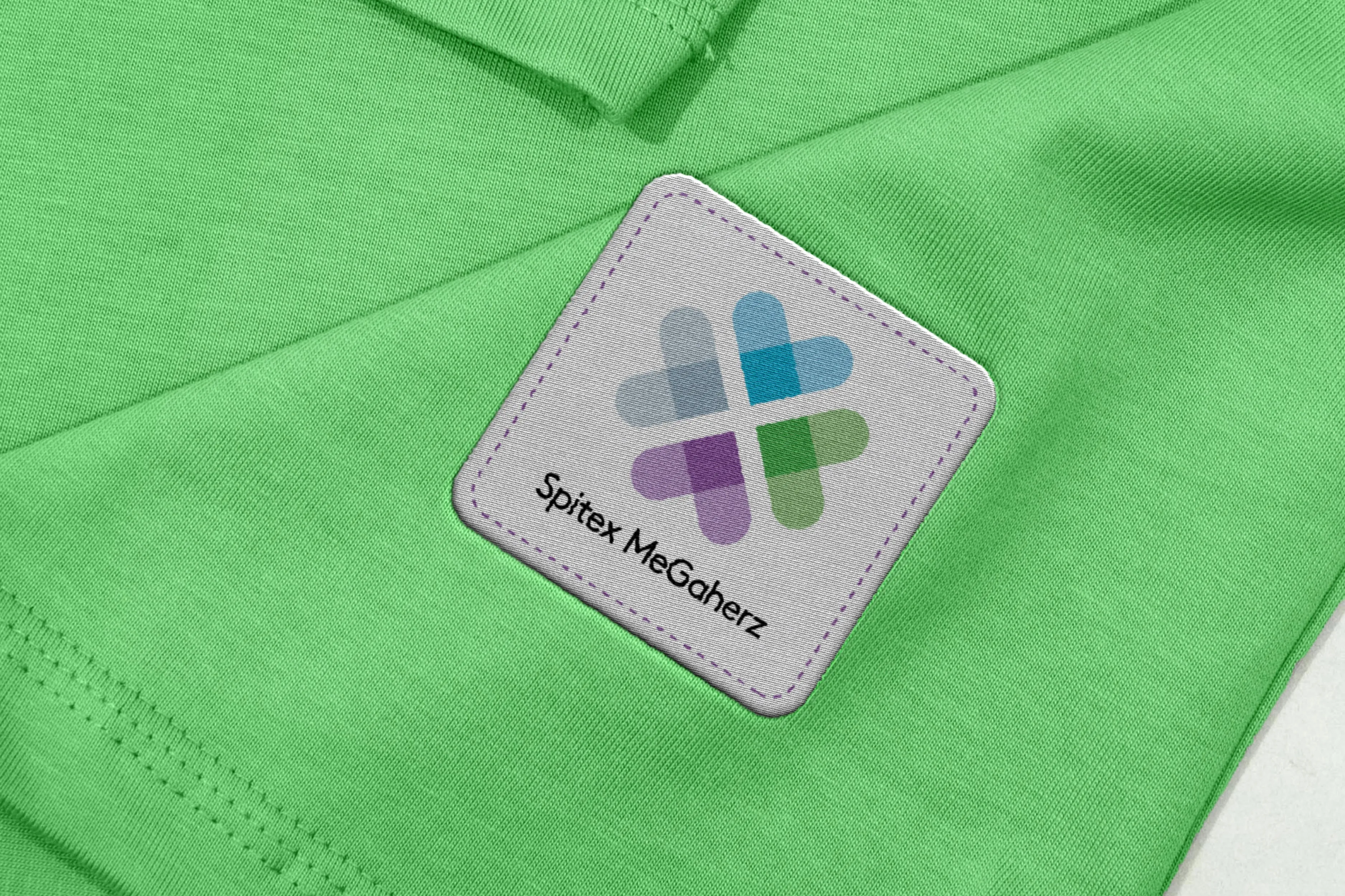 Woven Spitex MeGaherz brand patch on green sleeve, macro